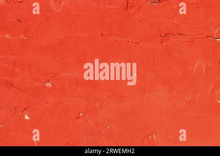 Grungy texture wall. Texture of red old shabby plaster on the wall. Red plaster surface. Stock Photo