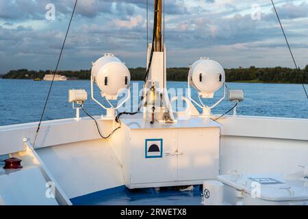 a ship's bell on the bow of a ship going down the river. ship 's rynda. the front of the ship Stock Photo