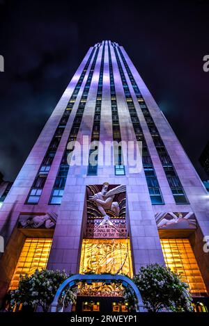 Looking Up the Facade of 30 Rockefeller Plaza, the Centerpiece of Rockefeller Center, at Night - Manhattan, New York City Stock Photo