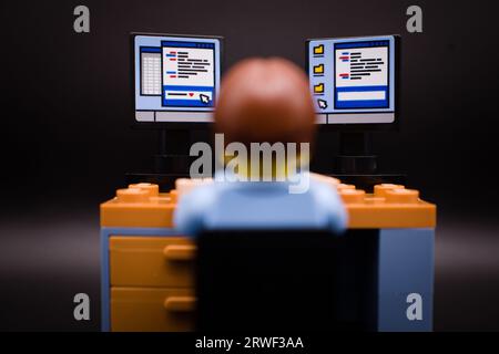 IT guy sitting in front of his computer with multiple screens Stock Photo