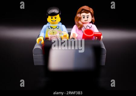 Watching TV with a hot cup of tea Stock Photo