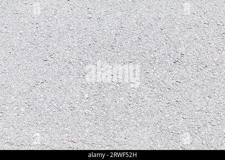 Blacktop texture. Asphalt road light grey blacktop background. Rough road surface. Stock Photo