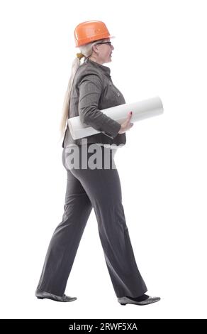 female architect with a roll of drawings striding towards you Stock Photo