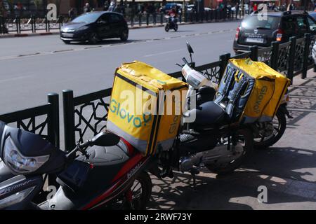 MARRAKECH, MOROCCO - FEBRUARY 21, 2022: Glovo mobile app food delivery scooters parked in the sidewalk in Marrakech, Morocco. Stock Photo