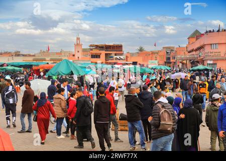 MARRAKESH, MOROCCO - FEBRUARY 20, 2022: People visit Jamaa el-Fnaa square market of Marrakesh city, Morocco. The square is listed as UNESCO Masterpiec Stock Photo