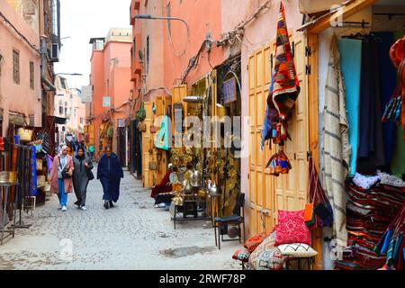 MARRAKESH, MOROCCO - FEBRUARY 20, 2022: People visit souk in medina (Old Town) of Marrakesh city, Morocco. The historic medina quarter is a UNESCO Wor Stock Photo