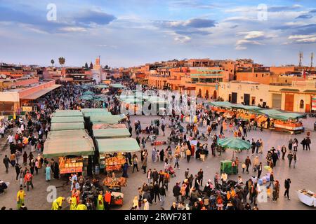 MARRAKESH, MOROCCO - FEBRUARY 20, 2022: People visit Jemaa el-Fnaa (Djemaa el Fna) square market of Marrakesh city. The square is listed as UNESCO Mas Stock Photo