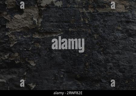 Dark wall background. Rough dark grungy concrete texture. Stock Photo