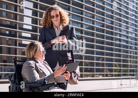 business woman showing tablet to man Stock Photo