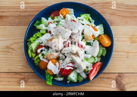 Chicken Caesar salad, a healthy salad made with lettuce, tomatoes, cucumber, celery and chicken. Stock Photo