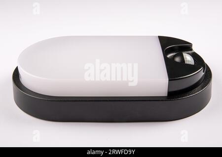 Led lamp with a motion sensor on a white background. Close up. Stock Photo