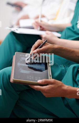 Hands of medical nurse analyzing chest x-ray on tablet computer Stock Photo