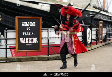 Shaun Williamson as Hook next to HMS Warrior at Portsmouth Historic Dockyard during a photocall for Hook - The Further Adventures of Peter Pan. The festive production at the Kings Theatre Portsmouth will run from December 1. Picture date: Tuesday September 19, 2023. Stock Photo