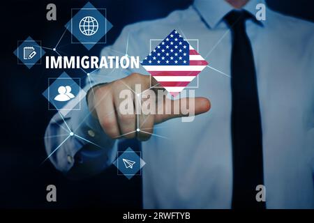 Immigration. Businessman touching digital screen with icons, word and flag of America on dark blue background, closeup Stock Photo