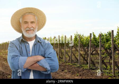 Confident farmer with crossed arms in field. Harvesting season Stock Photo