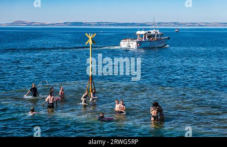 Children swiming in sea in hot Summer weather, North Berwick harbour, East Lothian, Scotland, UK Stock Photo