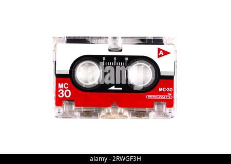 vintage analog audio micro cassette with transparent case and visible tape from the 90s isolated on white Stock Photo