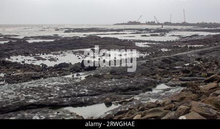 Rocky beach along the Arabian sea coast, Bandstand Promenade in Bandra, Mumbai. Stock Photo