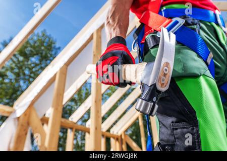 Caucasian Construction Site Carpenter with Large Hammer in His Hand Close Up Stock Photo