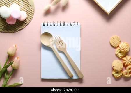 Top view of open spiral blank notebook on pink desk. Stock Photo