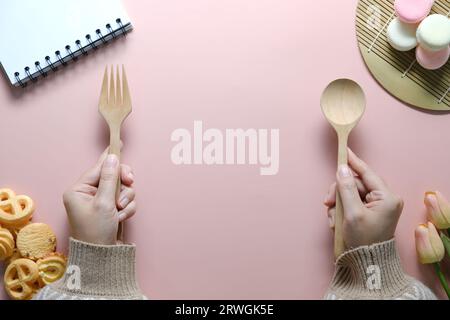 Top view of open spiral blank notebook on pink desk. Stock Photo