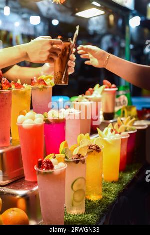 Many smoothie and drinks in plastic cups in Jalan Alor street food in the Kuala Lumpur market Stock Photo