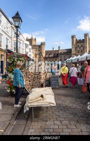 Market day in Wells Market Place on a sunny September day with people enjoying the many market stalls, City of Wells, Somerset, England, UK Stock Photo
