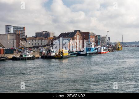 Boats moored at the harbourside in Poole Harbour, Poole, Dorset, England, UK Stock Photo