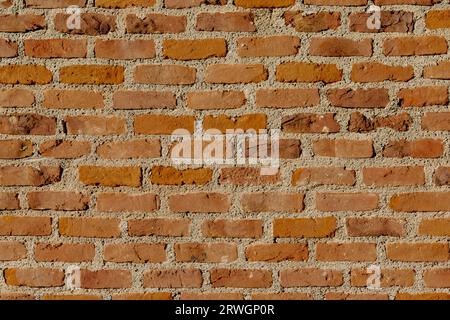 brick wall of red color. brick wall with lots of cement. Stock Photo