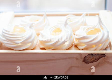 Close up of whipped baked meringues on wooden box Stock Photo