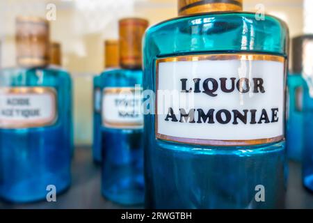 Antique apothecary blue glass jar / bottle with Liquor Ammoniae, also known as Ammoniacal Liquor in vintage pharmacy Stock Photo