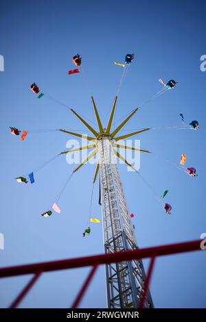 Arnsberg, NRW, Germany - 09 10 2023, Chain carousel at dizzying heights, blue sky as background Stock Photo