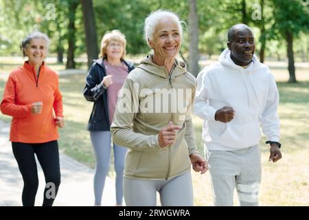 Elderly people running together in the morning in the park Stock Photo