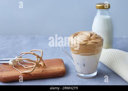 Dalgona coffee on a gray background. Fashionable drink with fluffy creamy based on milk, coffee and sugar. Copy space. Stock Photo