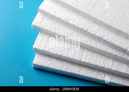 Styrofoam sheets on blue background Stock Photo
