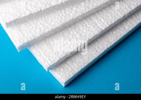 Styrofoam sheets on blue background Stock Photo