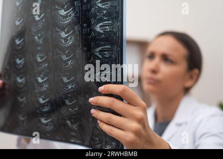 close up doctor conducts an online consultation, examining patient X-ray films and MRI scans Stock Photo