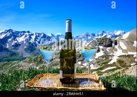 Glass and bottle of dry white Roussette de Savoie or Vin de Savoie wine from Savoy region served on Col du Galibier border Savoy region, France, view Stock Photo