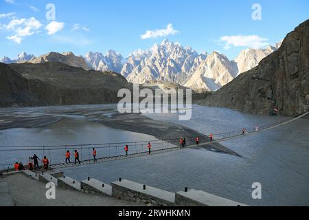 Tourists crossing the famous Hussaini Bridge in Pakistan Stock Photo