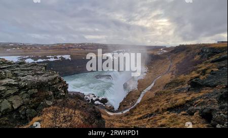 Spectacular Gullfoss waterfall in icelandic region, majestic river flow pouring down frosty hilltop edges. Nordic nature presents cascade running off cliffs in iceland, water stream. Stock Photo