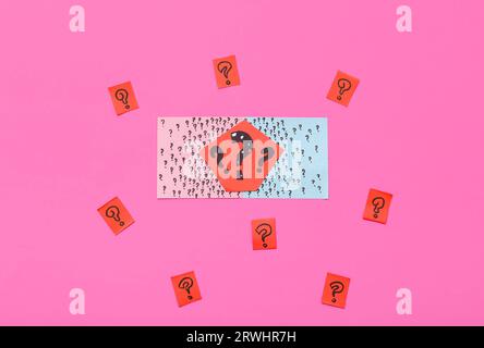 Paper quiz card with question marks on pink background Stock Photo