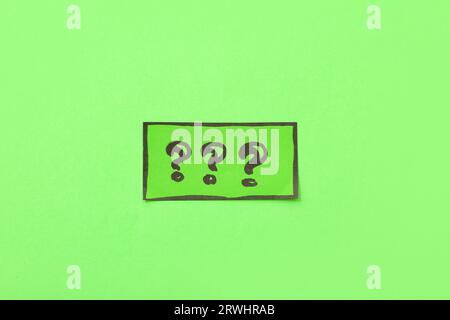 Quiz card with question marks on green background Stock Photo