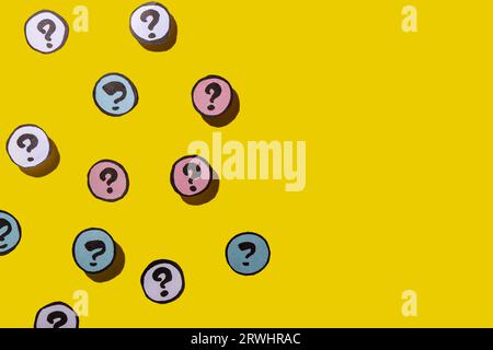 Different question marks on yellow background Stock Photo