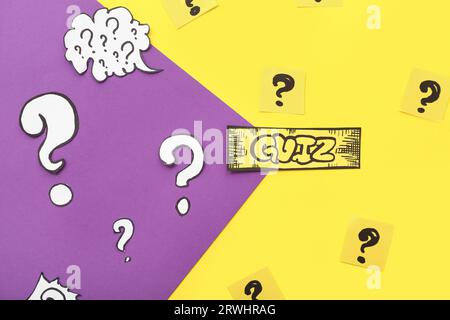 Paper quiz card with question marks on color background Stock Photo