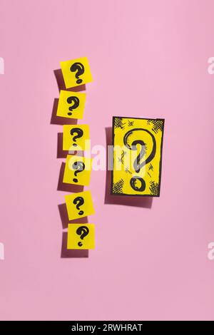 Quiz card with question marks on pink background Stock Photo