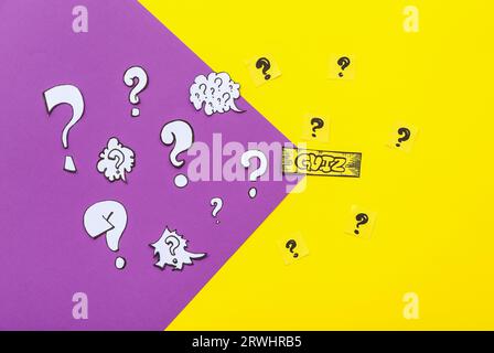 Paper quiz card with question marks on color background Stock Photo