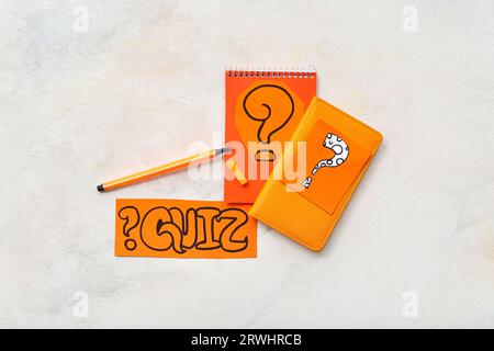 Notebooks and quiz cards with question marks on grunge white background Stock Photo