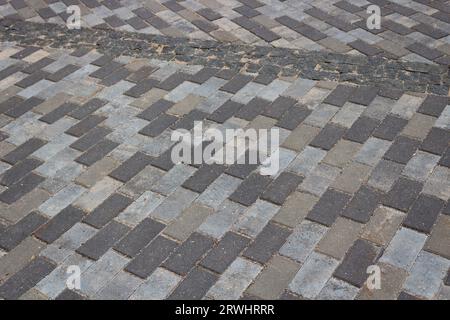 Background in the form of motley gray concrete tiles of a rectangular shape. Stock Photo
