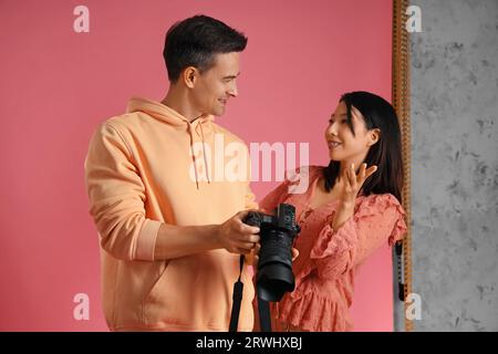 Female photographer working with Asian model in studio Stock Photo