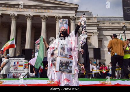 London, UK. 16th Sep, 2023. A protester is covered in fake blood and photos of the victims of the Iran regime during the rally in Trafalgar Square. British Iranians held several protests around London against the Iran regime to mark the anniversary of the death of Mahsa Amini, as well as the protests and the government crackdown which followed in Iran. (Credit Image: © Vuk Valcic/SOPA Images via ZUMA Press Wire) EDITORIAL USAGE ONLY! Not for Commercial USAGE! Stock Photo